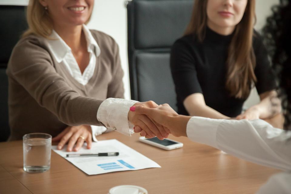 Professional woman shaking hands with another