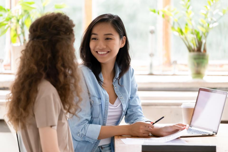 2 ladies having a conversation while working