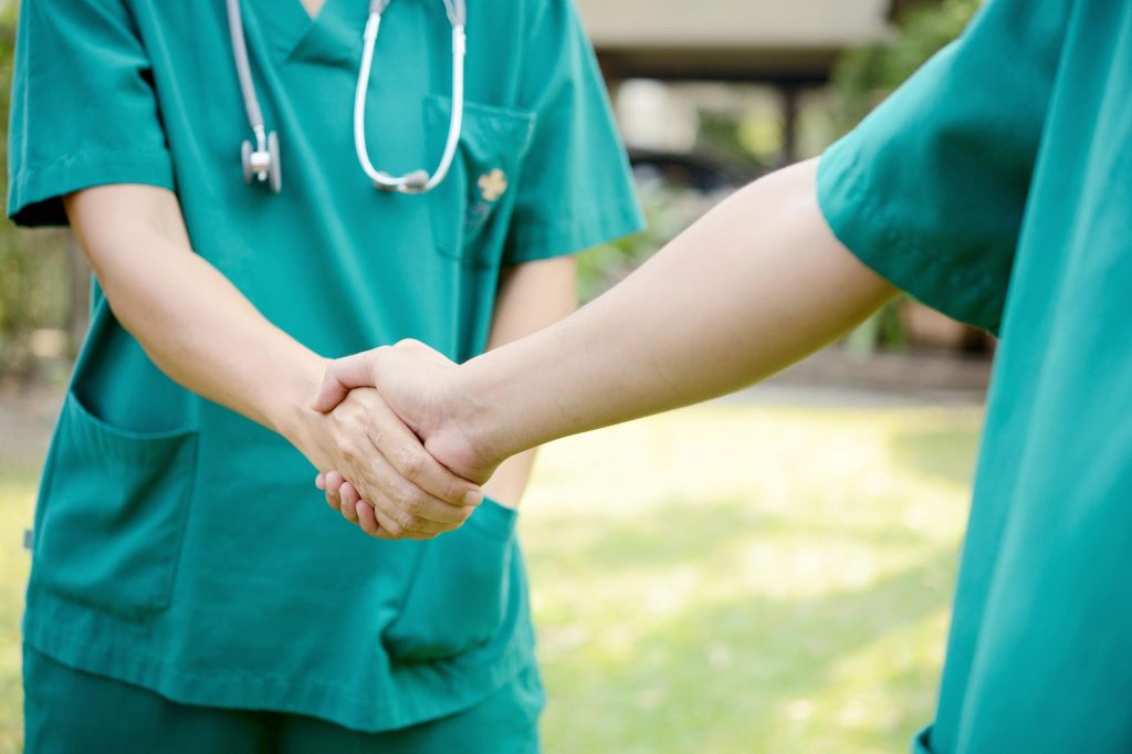 2 nurses shaking hands